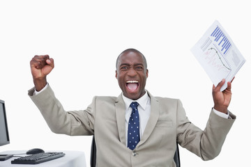 Wall Mural - Victorious salesman with the fists up while holding a graph