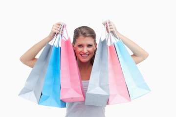 Joyful woman holding shopping bags