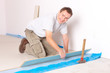 © Monika Wisniewska - Worker installing a laminated flooring