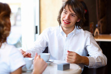Young Handsome Man Sitting In Restaurant