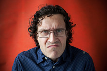 Man Wearing Glasses With A Grimace Of Displeasure