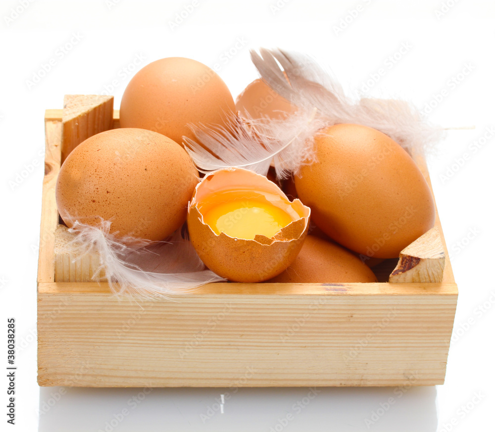 chicken eggs in wooden box isolated on white