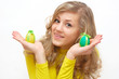 pretty teenage girl keeping two decorated easter eggs