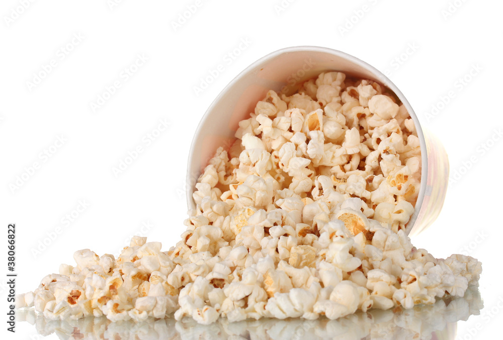 Full bucket of popcorn dropped isolated on white