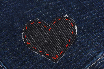 heart-shaped patch on jeans closeup