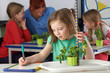 © micromonkey - Girl learning about plants in school class