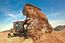 Wheel Loader Machine Unloading Soil At Construction Site
