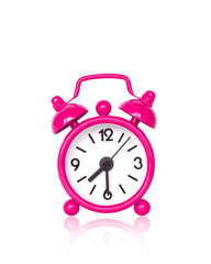 Pink alarm clock on white background with copy space