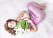 Romantic lovely young girl with bouquet of fresh tulips