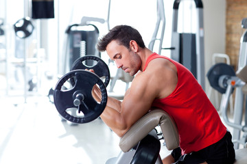 Wall Mural - man with weight training equipment on sport gym