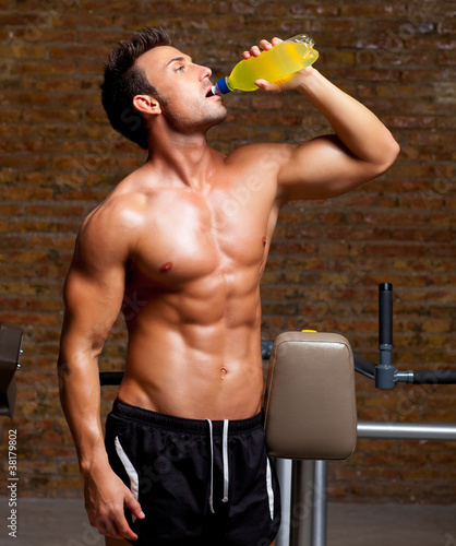 Fototapeta na wymiar muscle man at gym relaxed with energy drink