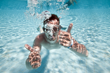 man floats in pool