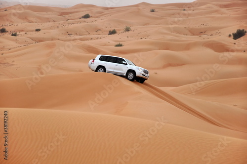 Fototapeta na wymiar jeep safari in the sand dunes of the arabian desert