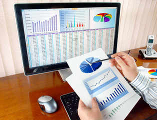 Fototapete - Businessman analyzing investment charts at his workplace