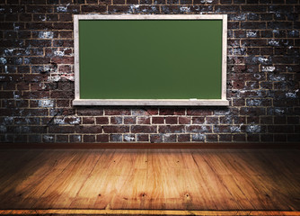 green blackboard with wooden frame on brick wall