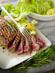 sliced steak with green salad