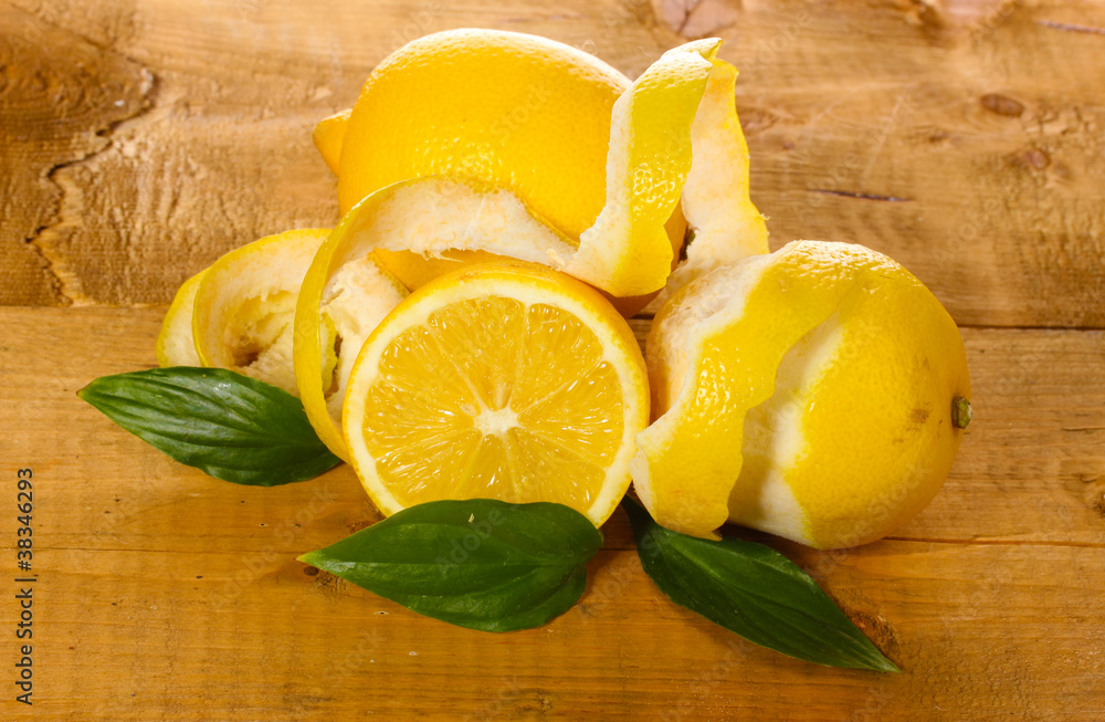 ripe lemons with leaves on wooden table