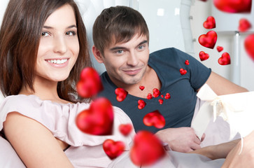 Closeup portrait of a happy young couple relaxing on the bed. Ma