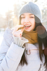 Portrait of young beautiful girl having fun outdoors in winter f