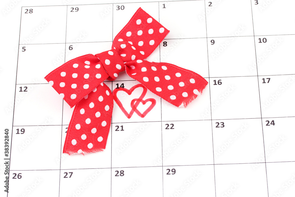 Calendar page with hearts and bow on St.Valentines Day