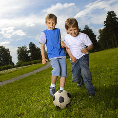 Wall Mural - two happy boy play in soccer