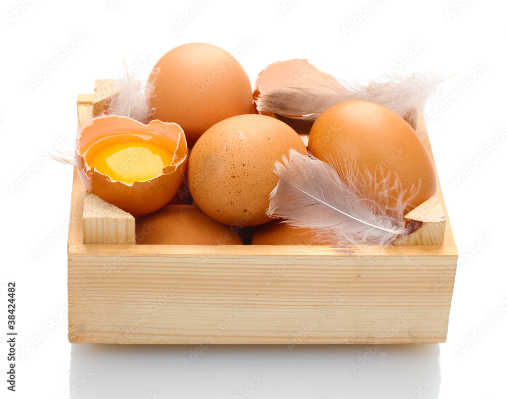 chicken eggs in wooden box isolated on white
