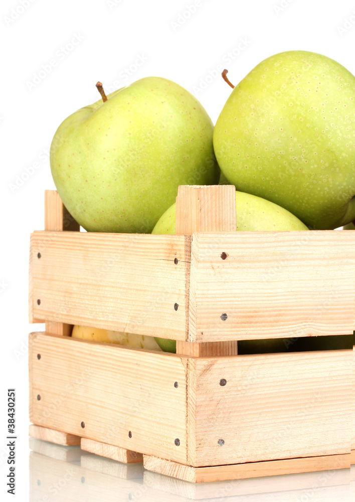 juicy green apples in a wooden crate isolated on white