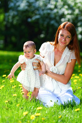 Mother and daughter on the green grass