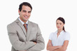 © WavebreakmediaMicro - Smiling salesman with colleague behind him