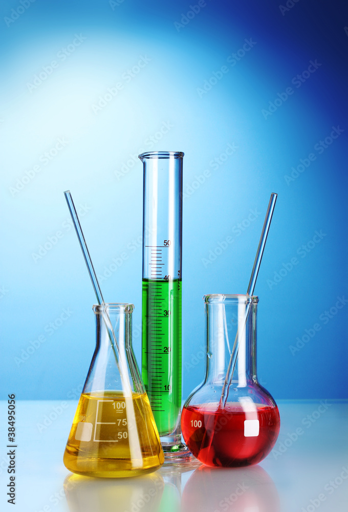 Three flasks with color liquid with reflection