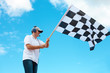 © Monika Wisniewska - Man waving a checkered flag on a raceway