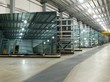 Large sheets of glass in a factory storage aera.