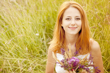 Wall Mural - Redhead girl at outdoor with flowers.