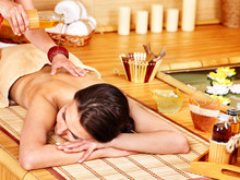Woman Getting Massage In Bamboo Spa.