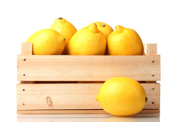 ripe lemon in wooden box isolated on white