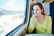 © lightpoet - Young woman traveling by train