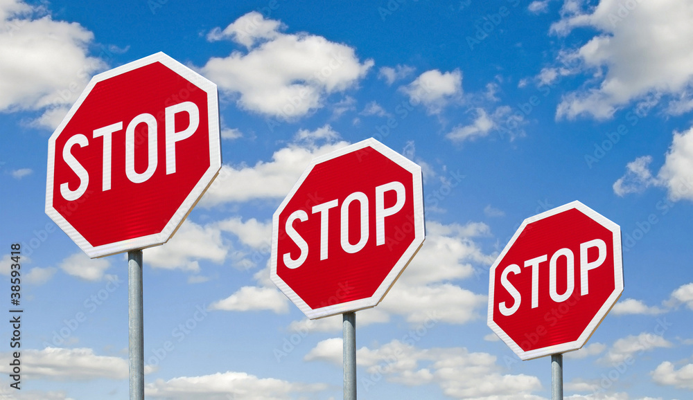 Stop signs - against the sky - obrazy, fototapety, plakaty 