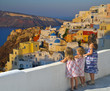 Little girls watching the sunset over Oia village - Greece