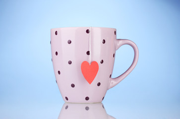 Wall Mural - pink cup and tea bag with red heart-shaped label