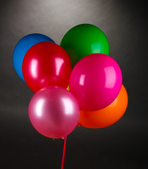 bright balloons on gray background