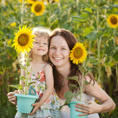 Canvas Print - Woman and child with sunflower