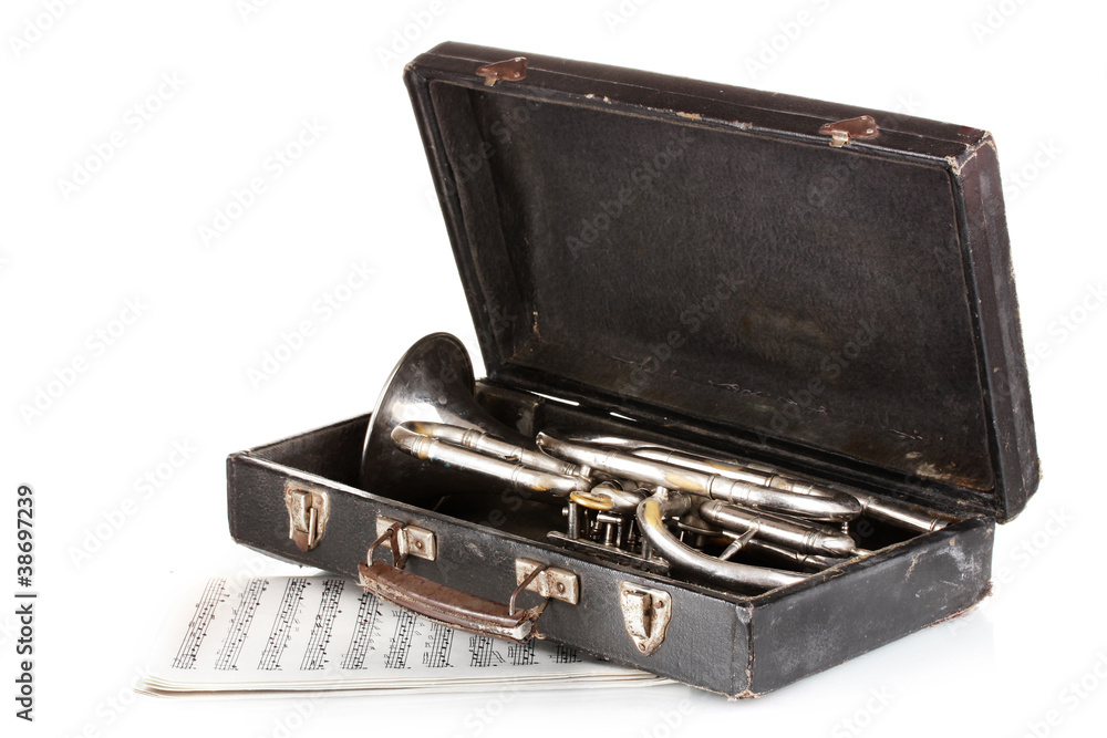 old trumpet in case and notebook with notes isolated on white