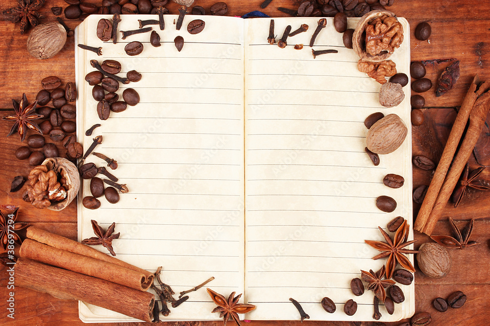 old paper for recipes and spices on wooden table