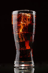 Canvas Print - Glass of cola with ice on black background