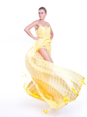 Beautiful dancer wearing yellow dress isolated on white