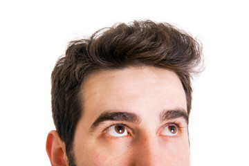 Young man looking up on white background