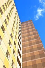 Poster - facade of skyscraper with apartments with blue sky