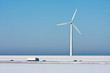 © Kruwt - Snowy landscape with a big windturbine and a highway in front of