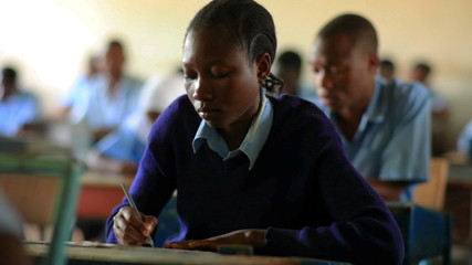 Wall Mural - African female student testing in classroom class in Kenya, Africa.
