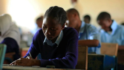 Wall Mural - Students taking a test in a class in Kenya.